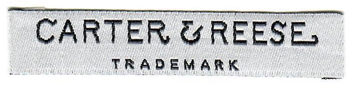 Finished woven Carter & Reese labels cut and folded ready for application